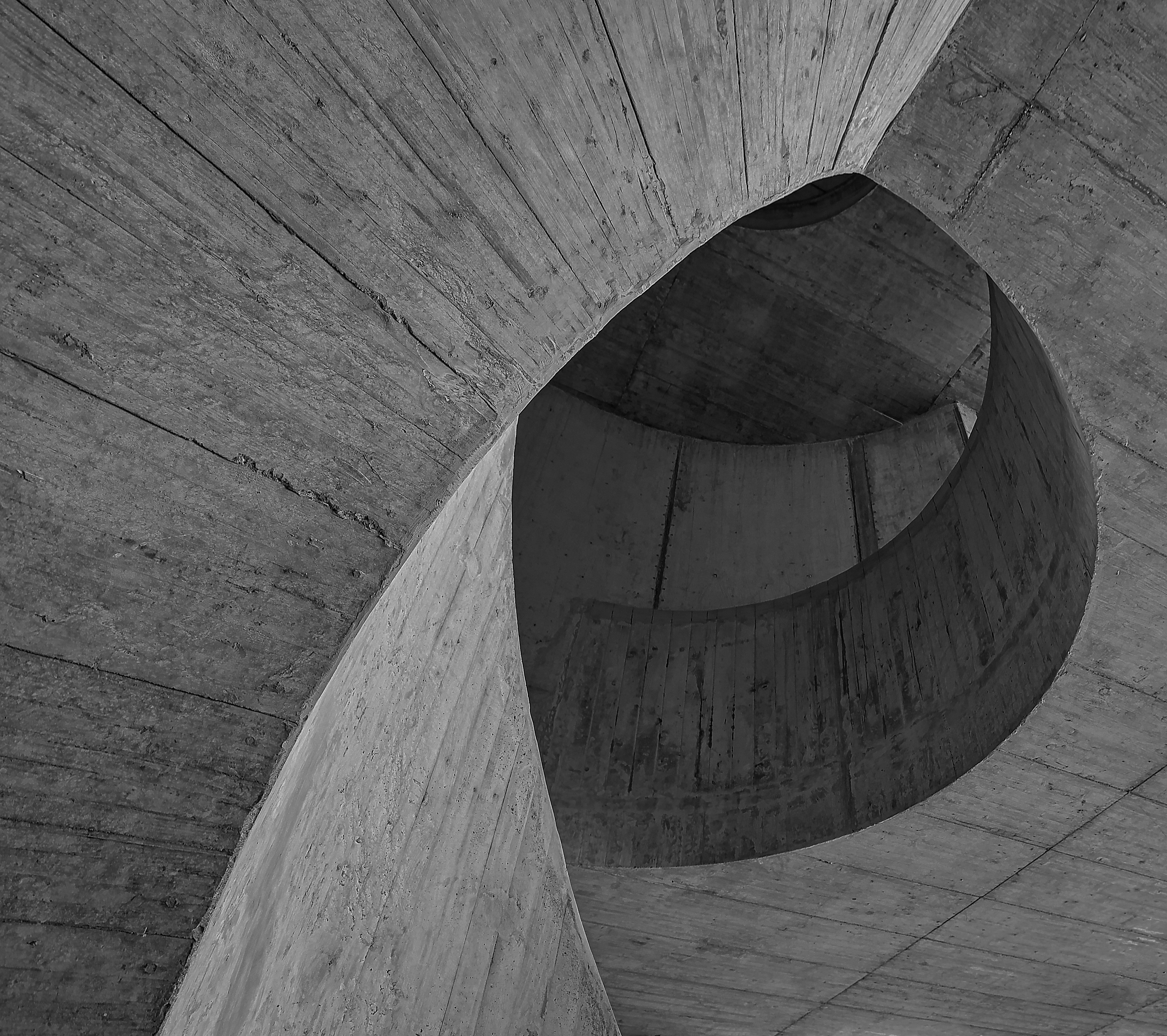 grayscale photo of wooden tunnel